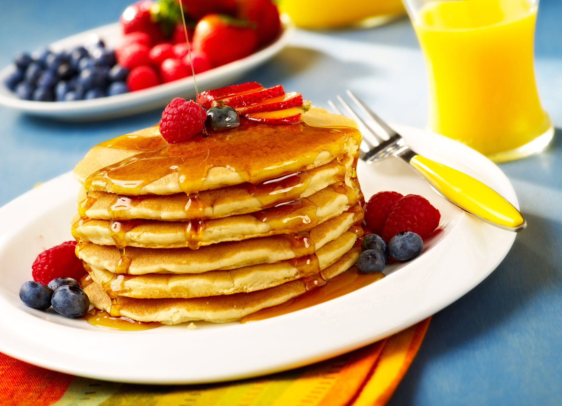 Delicious pancake stack with berries and syrup photo. 