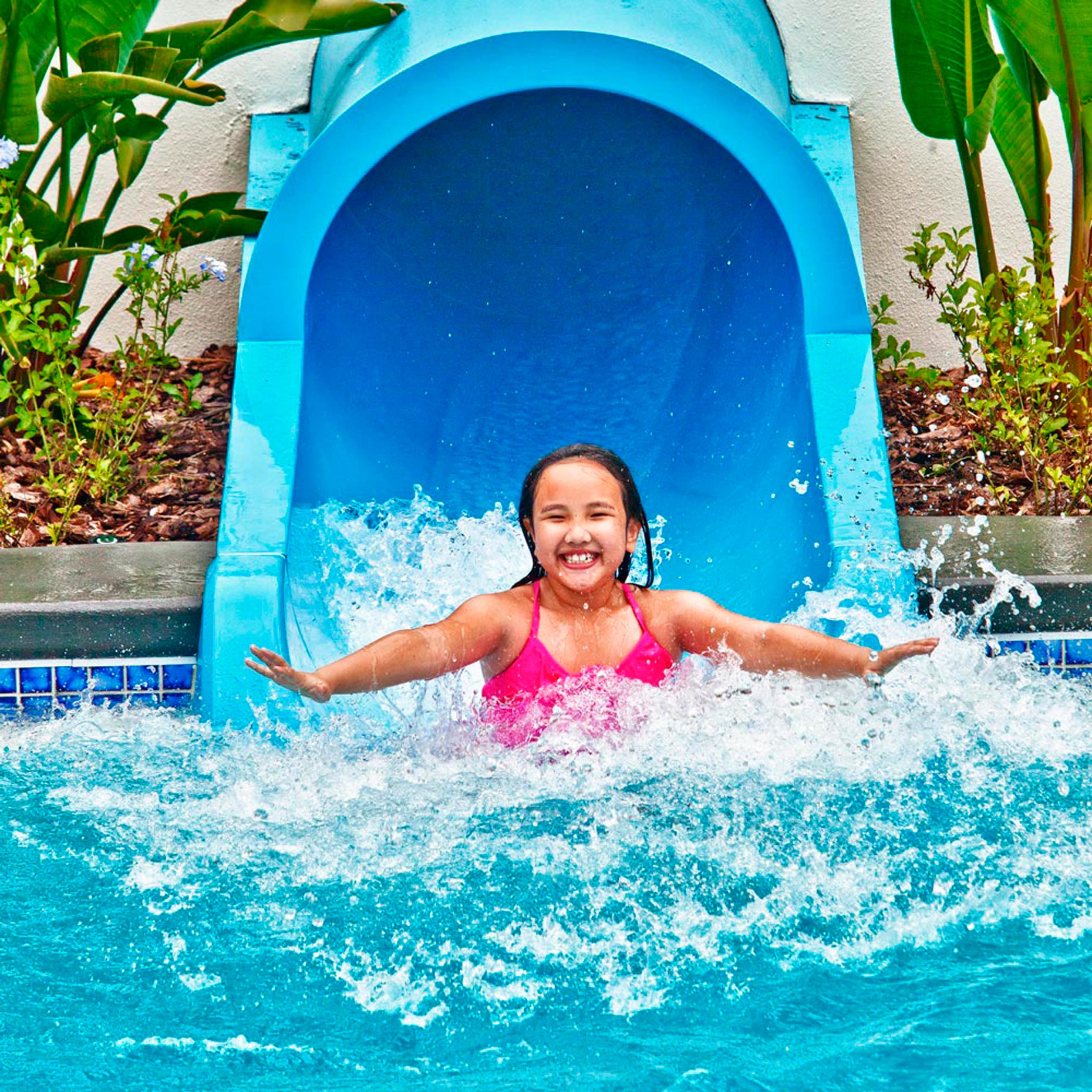   Lifestyle Photography | Hotel & Resort Photographer|Girl on Pool slide